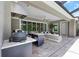 The outdoor kitchen features bar seating and a stainless steel grill at 4287 Woodland Retreat Blvd, New Port Richey, FL 34655