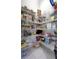 Walk-in pantry with white wire shelving stocked with assorted groceries and household goods at 4287 Woodland Retreat Blvd, New Port Richey, FL 34655