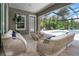 Relaxing covered patio area with comfortable seating and a view of the sparkling pool at 4287 Woodland Retreat Blvd, New Port Richey, FL 34655