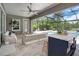 Relaxing covered patio area with comfortable seating and a view of the sparkling pool at 4287 Woodland Retreat Blvd, New Port Richey, FL 34655