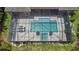 Screened in pool with ample patio, a hot tub, and outdoor seating at 4287 Woodland Retreat Blvd, New Port Richey, FL 34655