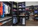 Custom walk-in closet with built-in shelving and storage space, including laundry bins at 4287 Woodland Retreat Blvd, New Port Richey, FL 34655