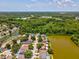 An aerial view of the single Gathering homes in a lakeside community surrounded by trees and green space at 4716 Wolfram Ln, New Port Richey, FL 34653