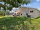 Backyard with patio, lawn, and a lake view, plus a swing at 4716 Wolfram Ln, New Port Richey, FL 34653