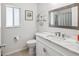 Bright bathroom features a marble vanity, modern fixtures, and a decorative framed mirror at 4716 Wolfram Ln, New Port Richey, FL 34653