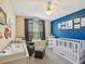 Cozy bedroom with blue accent wall, modern furniture, and decor, creating a playful and inviting atmosphere at 4716 Wolfram Ln, New Port Richey, FL 34653