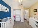 Stylish bedroom offering modern furniture, spacious closet, and playful decor for a comfortable and organized space at 4716 Wolfram Ln, New Port Richey, FL 34653