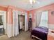 Charming bedroom with peach colored walls, plush carpet, and cute decor elements for a comfortable ambiance at 4716 Wolfram Ln, New Port Richey, FL 34653