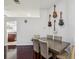 Elegant dining room features a dark wood table, upholstered chairs, and a collection of guitars on the wall at 4716 Wolfram Ln, New Port Richey, FL 34653