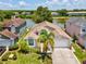 Charming single-story home with a two-car garage, manicured lawn, and a serene lake view at 4716 Wolfram Ln, New Port Richey, FL 34653