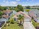 Charming single-story home with a two-car garage, manicured lawn, and a serene lake view at 4716 Wolfram Ln, New Port Richey, FL 34653