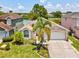 Charming single-story home with a two-car garage and a well-maintained lawn at 4716 Wolfram Ln, New Port Richey, FL 34653
