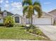 Charming single-story home featuring a well-manicured lawn and landscaping at 4716 Wolfram Ln, New Port Richey, FL 34653