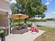 Lakeside patio furnished with comfortable seating and ' play area at 4716 Wolfram Ln, New Port Richey, FL 34653