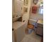 Small bathroom featuring a stackable washer/dryer, toilet, vanity, and mirror maximizing space and functionality at 6050 Chesham Dr # 3, New Port Richey, FL 34653