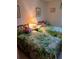 Bright bedroom featuring two twin beds with tropical-themed bedding and a bedside table with a lamp at 6050 Chesham Dr # 3, New Port Richey, FL 34653