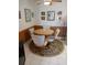 Cozy dining area with a round table, comfortable seating, and natural light at 6050 Chesham Dr # 3, New Port Richey, FL 34653