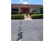 Charming building with a red door, surrounded by manicured landscaping and greenery at 6050 Chesham Dr # 3, New Port Richey, FL 34653