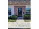 Inviting entryway with a storm door, well maintained landscaping, and clear house number at 6050 Chesham Dr # 3, New Port Richey, FL 34653