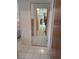 Hallway with large mirror that leads to various rooms at 6050 Chesham Dr # 3, New Port Richey, FL 34653