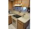 Kitchen with laminate countertops, a white oven, and neutral colored cabinetry at 6050 Chesham Dr # 3, New Port Richey, FL 34653