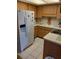 Functional kitchen with white appliances, tile flooring, and ample cabinet space at 6050 Chesham Dr # 3, New Port Richey, FL 34653