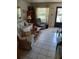 Bright living room featuring tile flooring, large windows, and comfortable seating arrangement at 6050 Chesham Dr # 3, New Port Richey, FL 34653