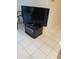 Living room featuring a modern television on a black stand against a neutral wall at 6050 Chesham Dr # 3, New Port Richey, FL 34653