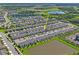 Aerial view of a neighborhood showcasing modern townhomes, lush greenery, and community ponds at 6240 Fairmont Ln, Palmetto, FL 34221