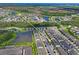 An aerial view of a neighborhood with a lake and manicured landscaping at 6240 Fairmont Ln, Palmetto, FL 34221