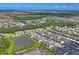 Wide aerial view of neighborhood homes and community pool at 6240 Fairmont Ln, Palmetto, FL 34221