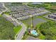 Aerial view of a community pool area, with lounge chairs, shade, and a community building at 6240 Fairmont Ln, Palmetto, FL 34221