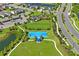 Aerial view of the community basketball court and playground, plus green spaces at 6240 Fairmont Ln, Palmetto, FL 34221