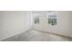 A bright bedroom with two windows overlooking the neighborhood and a walk-in closet at 6240 Fairmont Ln, Palmetto, FL 34221