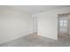 Empty bedroom featuring neutral carpeting and a view to the hallway and stairs at 6240 Fairmont Ln, Palmetto, FL 34221