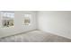 A bright bedroom featuring two windows overlooking the neighborhood at 6240 Fairmont Ln, Palmetto, FL 34221