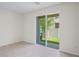 Bedroom featuring tile floors, a sliding glass door, and a view of the backyard at 6240 Fairmont Ln, Palmetto, FL 34221