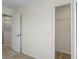 A bedroom showing an open closet door and neutral carpeting and trim at 6240 Fairmont Ln, Palmetto, FL 34221