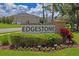 Attractive Edgestone at Artisan Lakes community sign with manicured landscaping, stone accents and flowering plants at 6240 Fairmont Ln, Palmetto, FL 34221