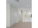 Hallway view of the home's interior, showcasing the kitchen and staircase at 6240 Fairmont Ln, Palmetto, FL 34221
