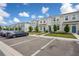 Exterior shot of townhomes, showing parking spaces and landscaped front yards at 6240 Fairmont Ln, Palmetto, FL 34221