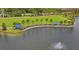 Scenic aerial view of a community park with lake, fountain, and covered picnic benches at 6240 Fairmont Ln, Palmetto, FL 34221