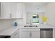 Modern kitchen with white cabinets, stainless steel appliances, and quartz countertops at 6240 Fairmont Ln, Palmetto, FL 34221