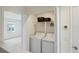 Convenient laundry area equipped with a washer, dryer, and storage shelf at 6240 Fairmont Ln, Palmetto, FL 34221