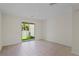 Open-concept living room with tile flooring and a sliding glass door to the backyard at 6240 Fairmont Ln, Palmetto, FL 34221