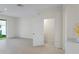 Living room area featuring neutral tile flooring, with an open powder room and sliding glass door at 6240 Fairmont Ln, Palmetto, FL 34221