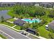Community pool and covered grilling area surrounded by lush tropical landscaping at 6240 Fairmont Ln, Palmetto, FL 34221