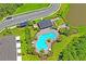 Community pool area featuring lush landscaping, comfortable lounge chairs, and covered picnic spaces at 6240 Fairmont Ln, Palmetto, FL 34221