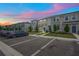 Street view of townhomes in the community with blue doors, sidewalks, parking spaces, and manicured lawns at 6240 Fairmont Ln, Palmetto, FL 34221