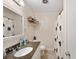 Bathroom with a granite countertop vanity, toilet, mirror, and shower with a pineapple curtain at 6795 23Rd S St, St Petersburg, FL 33712